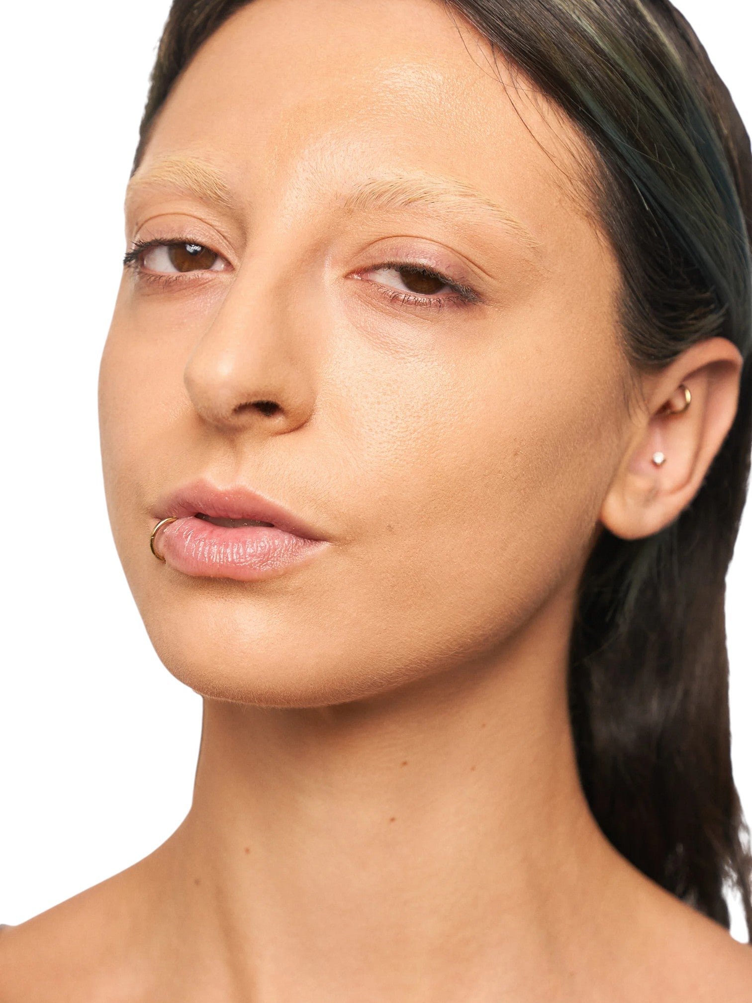 Close-up of a woman's face with a neutral expression on a white background. Kiko Milano, Monza Outlet, Monza Fashion, Shein Outlet