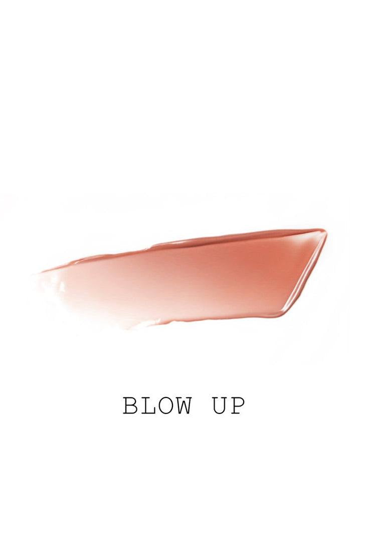 A swatch of the Pat McGrath Labs Lip Fetish Sheer Colour Balm in the shade Blow Up, showing a warm beige lip color. Monza Outlet