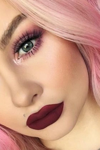 Close-up of a person with pink hair and dark red lipstick. Monza fashion outlet, monza outlet, shein outlet, shien outlet cosmetics, makeup, perfume