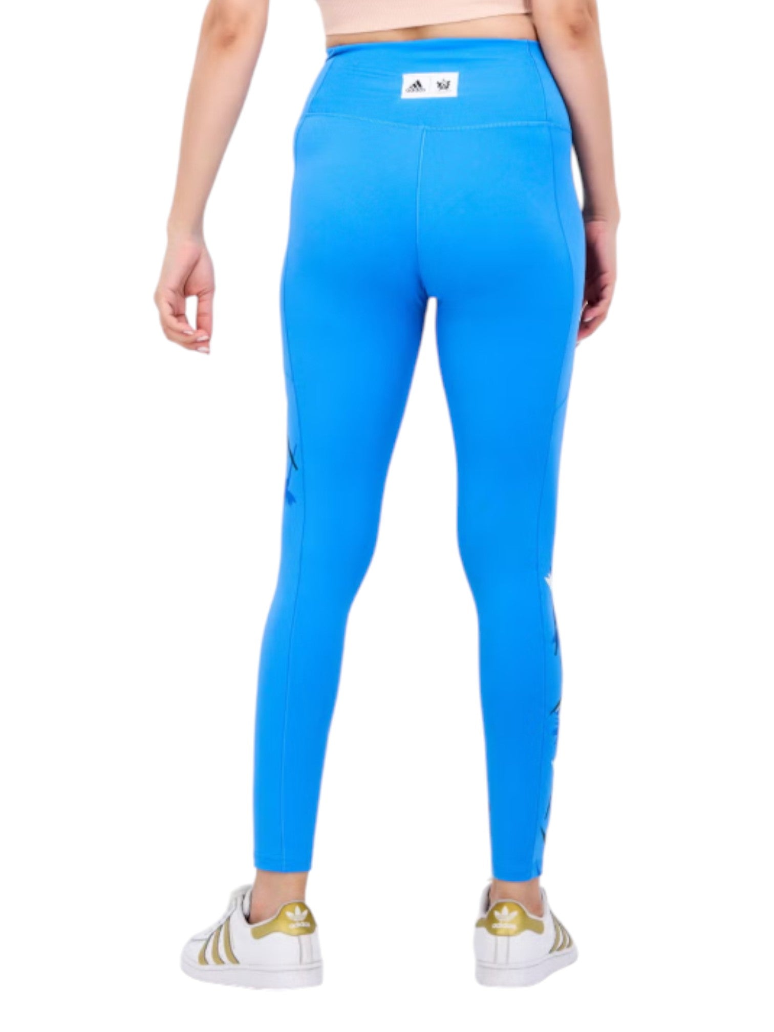 Person wearing bright blue leggings with a brand logo on a white background. Adidas, Monza Outlet, Monza Fashion, Shein Outlet