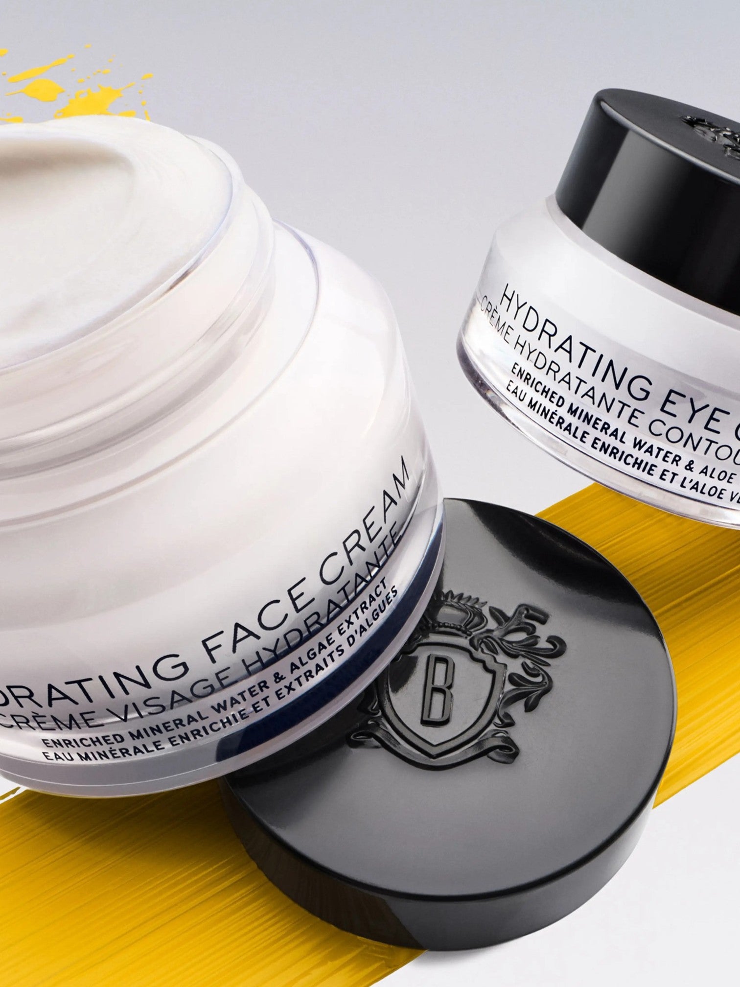 Two jars of hydrating face cream and eye cream with visible brand logo on a gray and yellow background. Bobbi Brown, Monza Outlet, Monza Fashion, Shein Outlet