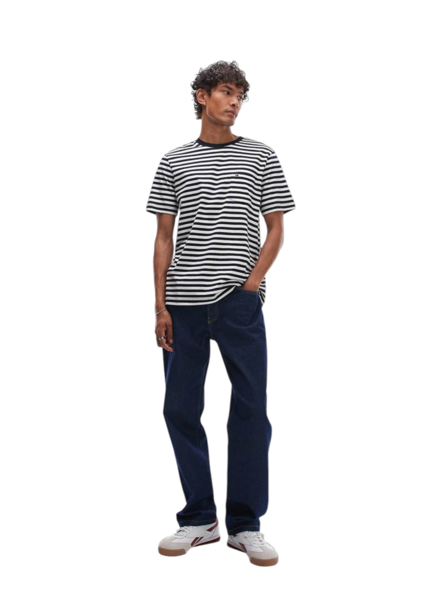 Person wearing a striped shirt and dark jeans on a white background. Tommy, Monza Outlet, Monza Fashion, Shein Outlet  