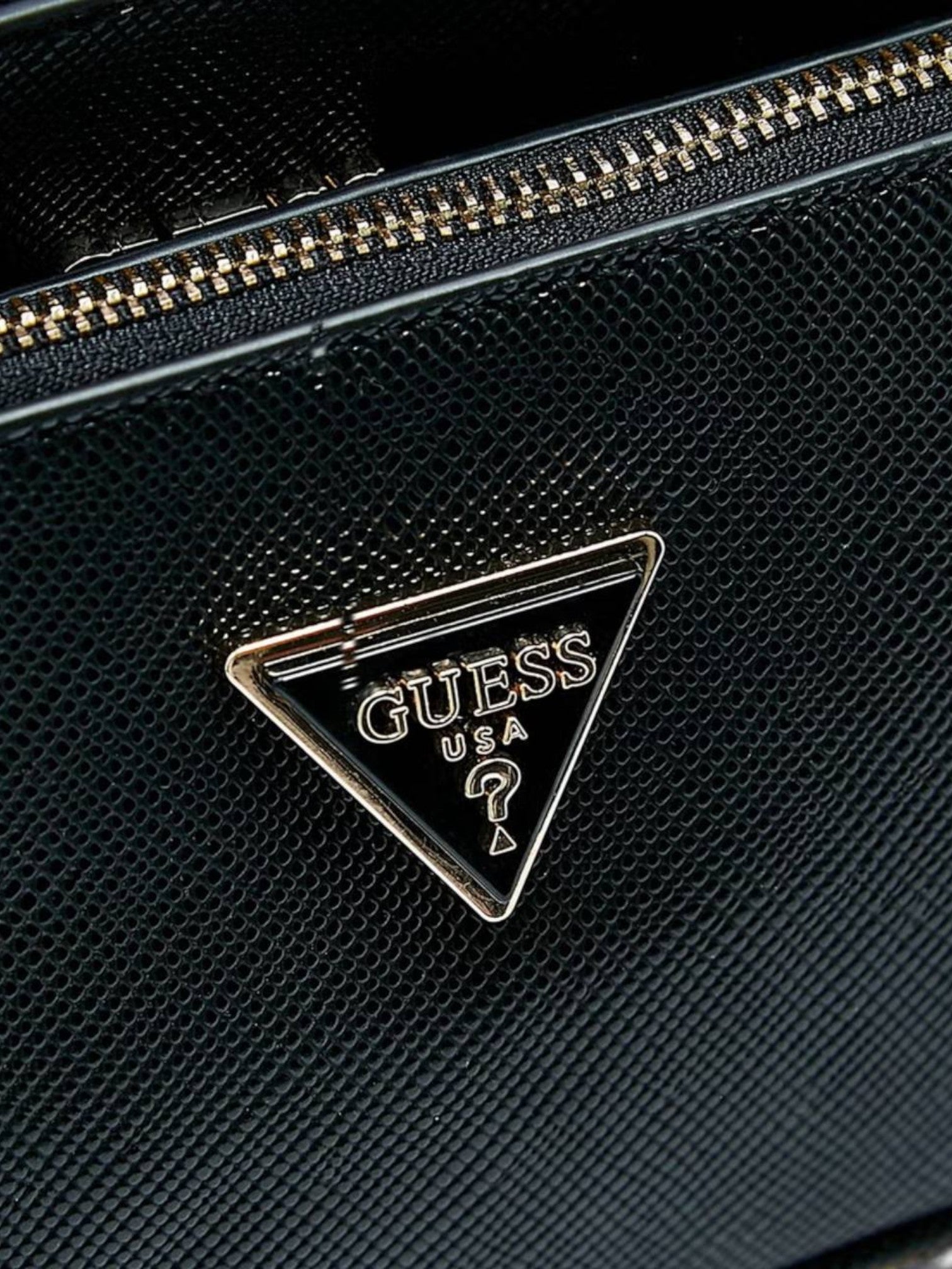 Black textured surface with Guess logo triangle emblem. Guess, Monza Outlet, Monza Fashion, Shein Outlet