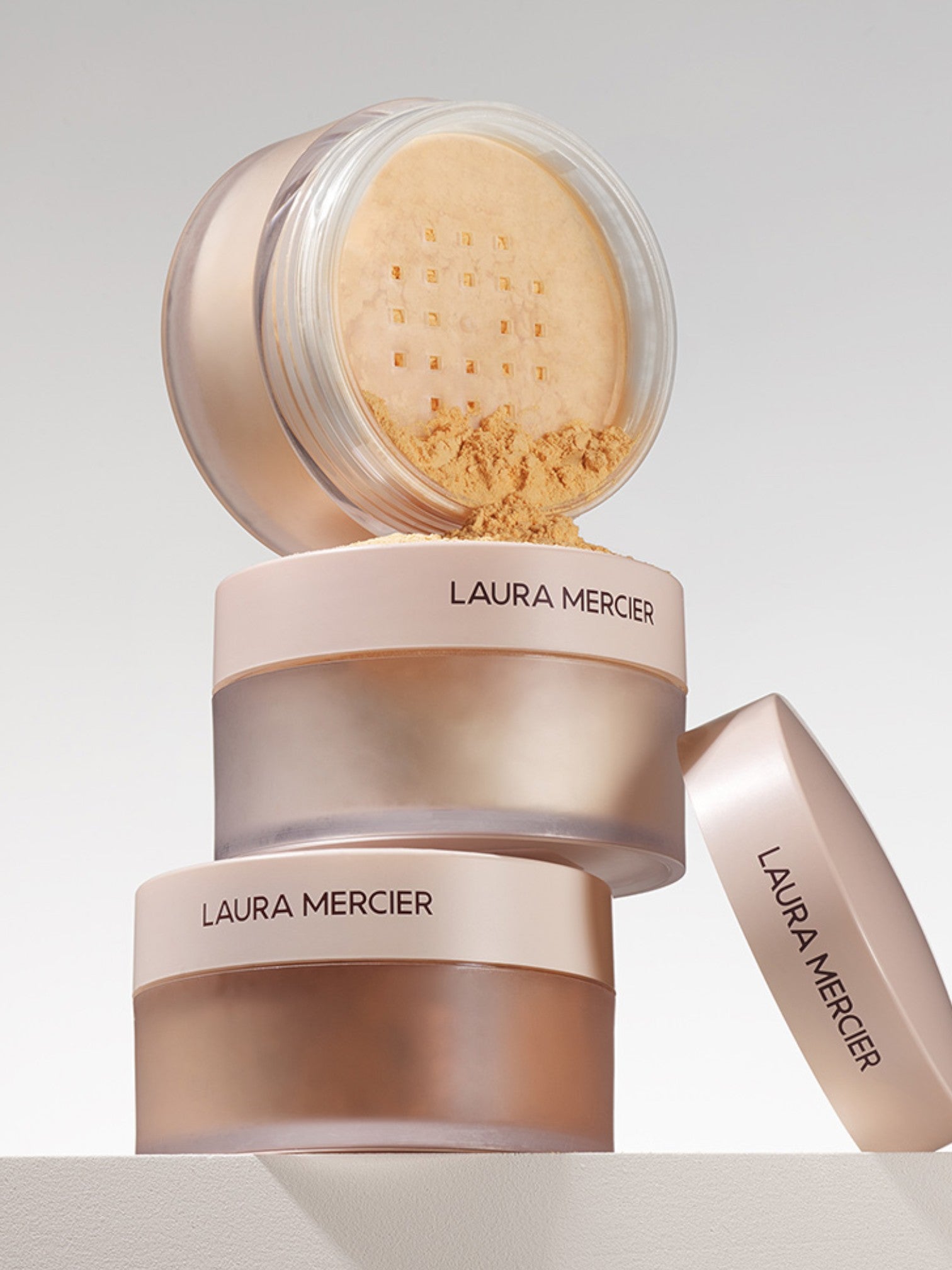 Laura Mercier powder compact on a light gray background  Laura Mercier Monza Outlet