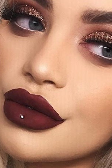 Close-up of a person with dark red lipstick and smoky eye makeup. Monza fashion outlet, monza outlet, shein outlet, shien outlet cosmetics, makeup, perfume