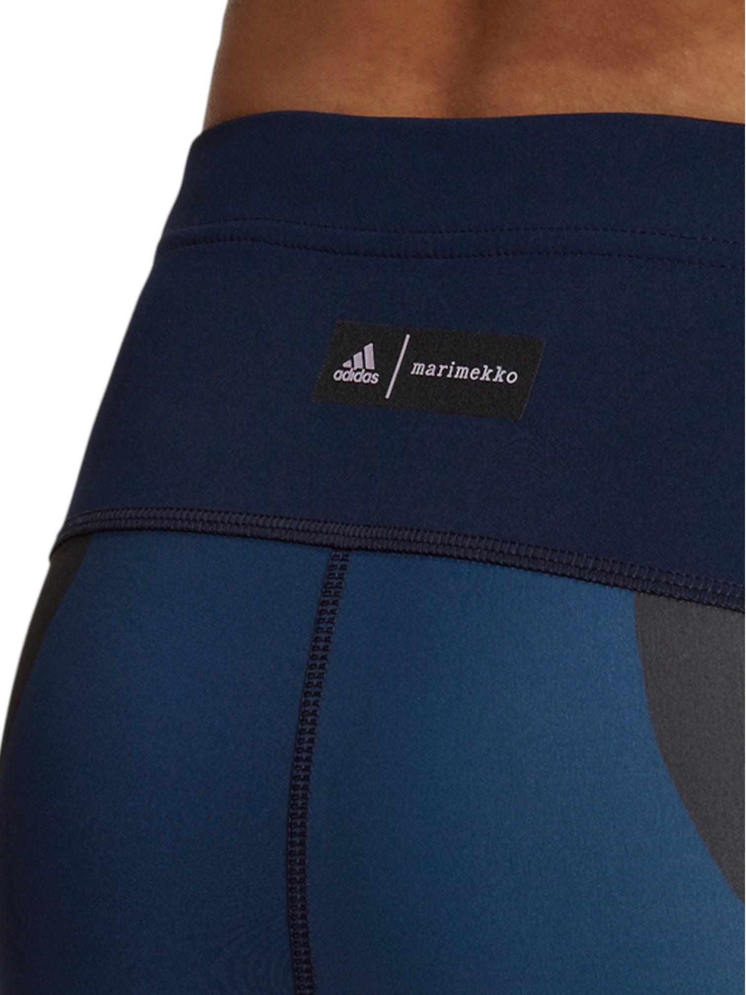 Close-up of a blue athletic outfit with Adidas and Marimekko labels. Adidas, Monza Outlet, Monza Fashion, Shein Outlet