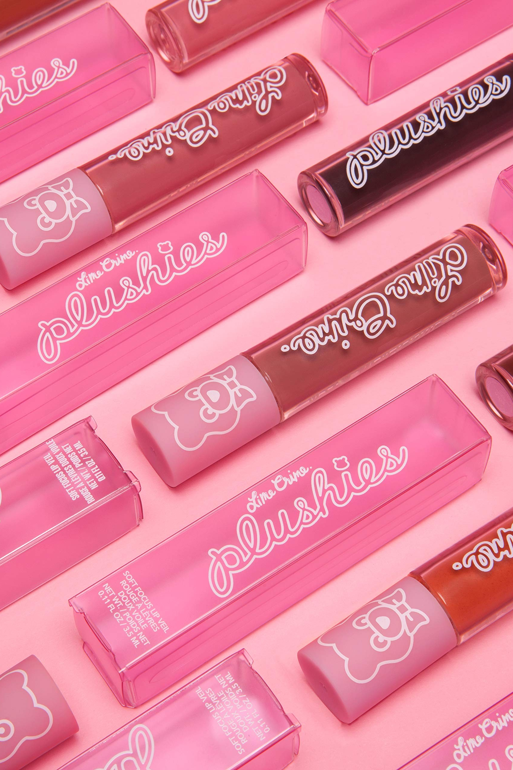 Collection of pink lip glosses with 'plushies' branding on a pink background Monza fashion outlet, monza outlet, shein outlet, shien outlet cosmetics, makeup, perfume