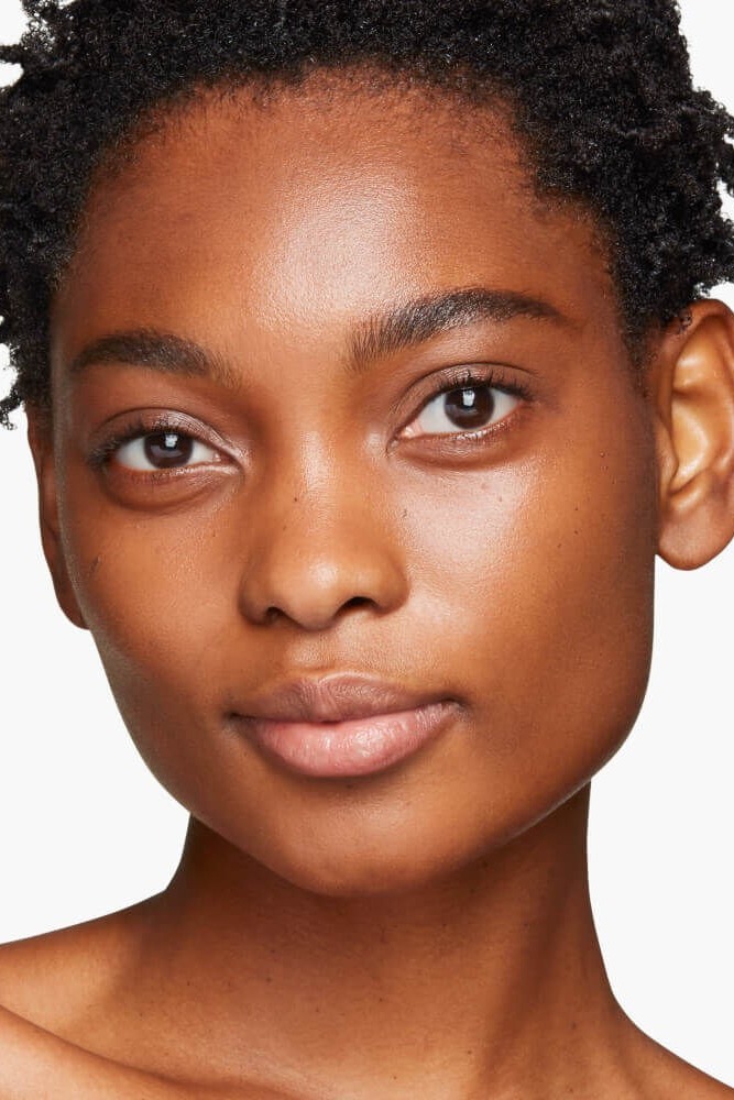 Close-up of a woman's face with a neutral expression on a white background Monza fashion outlet, monza outlet, shein outlet, shien outlet cosmetics, makeup, perfume