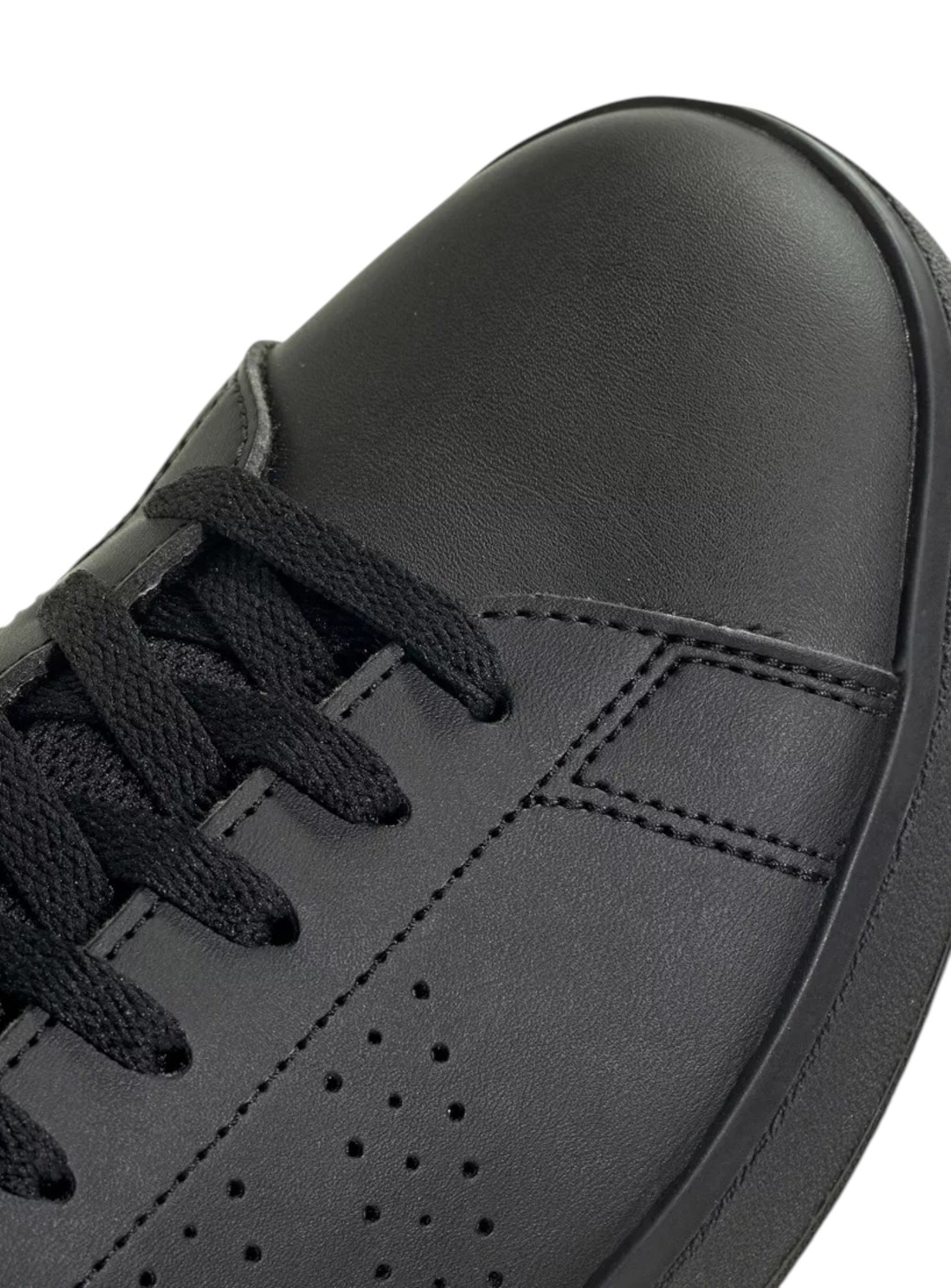 Close-up of a black sneaker with visible stitching on a white background. Adidas, Monza Outlet, Monza Fashion, Shein Outlet