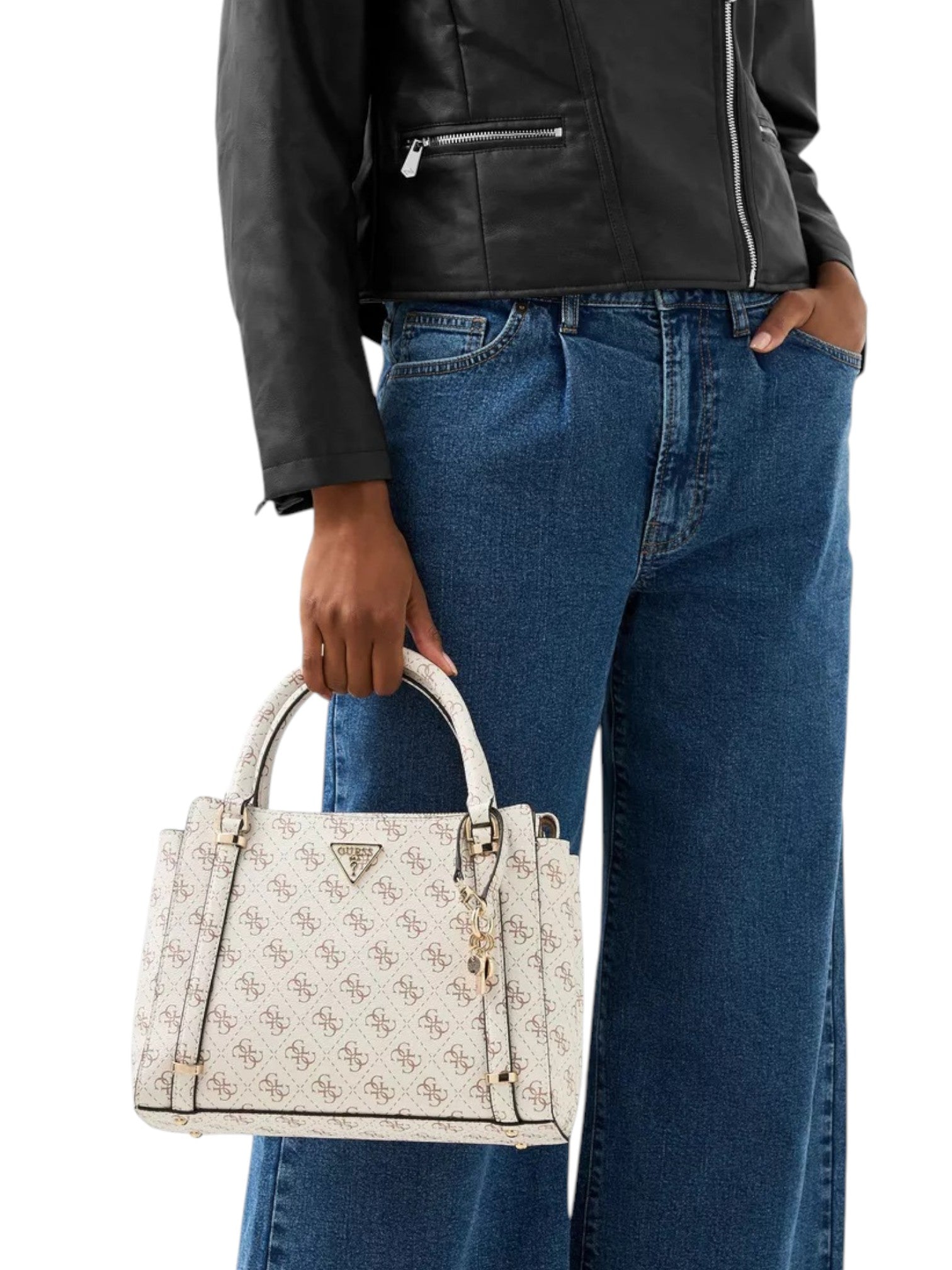 Person holding a white handbag with a pattern, wearing a black jacket and blue jeans. Guess, Monza Outlet, Monza Fashion, Shein Outlet