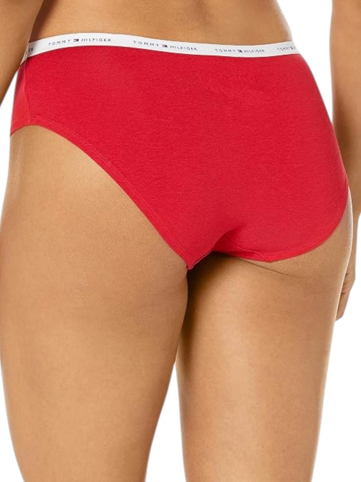 A close up of a model wearing bright red Tommy Hilfiger bikini style underwear, showing the back waistband with the white brand logo text. Tommy Hilfiger, Monza Outlet, Monza Fashion, Shein Outlet
